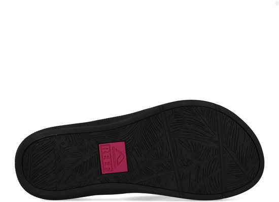 Zool van zwarte slipper met tropisch patroon en roze Reef logo.