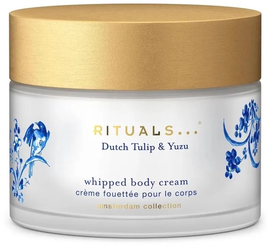 Wit potje met gouden deksel, bedrukt met blauwe vogels en bloemen. Text: RITUALS, Dutch Tulip & Yuzu, whipped body cream.