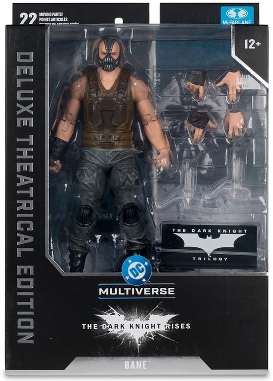 Actiefiguur van Bane in verpakking, met masker, bruin vest en grijze broek. "The Dark Knight Rises" logo zichtbaar.