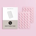 Twee roze zuignaptelefoonstickers naast een Selencia-verpakking met een schematische weergave.