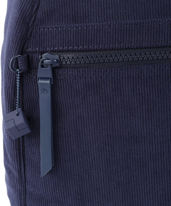 Detail van de ritssluiting en de donkerblauwe leren sleutelhanger van de Hedgren rugzak.