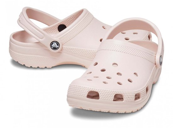 Lichtroze Crocs Classic Clogs, de ene achter de andere, met draagband om de enkel.