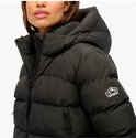 Close-up van een zwarte Superdry pufferjas met capuchon en logo op de mouw.