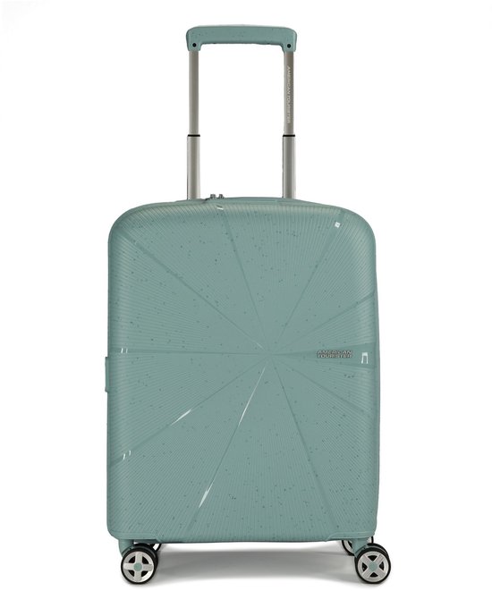 Mintgroene American Tourister koffer met sterpatroon en zilveren handvat.