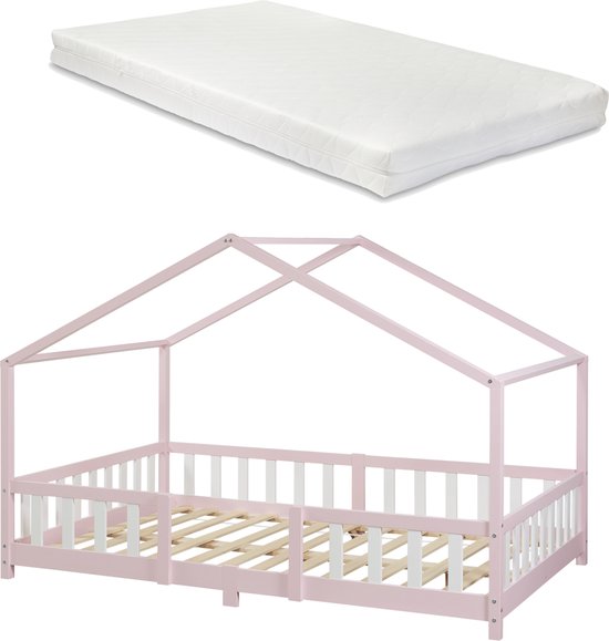 Roze kinderhuisbedframe met witte spijlen en houten lattenbodem, met een witte matras.
