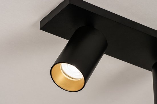 Spot cylindrique noir à intérieur doré, monté sur une base rectangulaire noire.