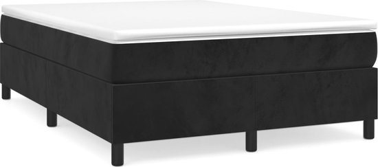 Lit boxspring noir avec matelas blanc, sur pieds en bois.