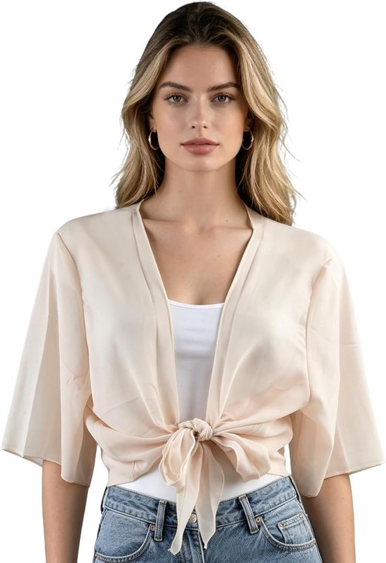 Mannequin aux longs cheveux blonds porte un boléro court en mousseline beige clair noué à l'avant.