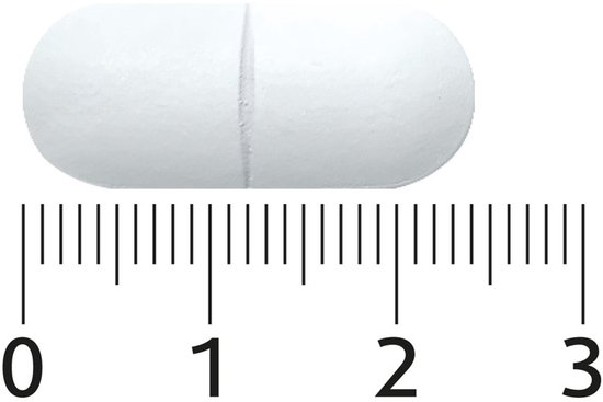 Eén witte capsule met een deelstreep, gemeten op een liniaal van 0 tot 3 cm.