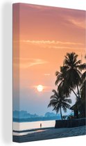 Canvas Schilderij Zonsondergang op een eiland met de silhouetten van palmbomen - 60x90 cm - Wanddecoratie