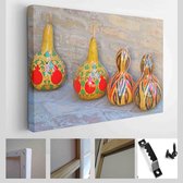 Interessante pompoenen geschilderd met oosters ornament tegen bakstenen muur - Modern Art Canvas - Horizontaal - 1097343131