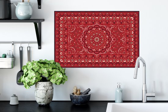 Une affiche de tapis persan rouge avec un design de mandala, accrochée dans un environnement de cuisine.