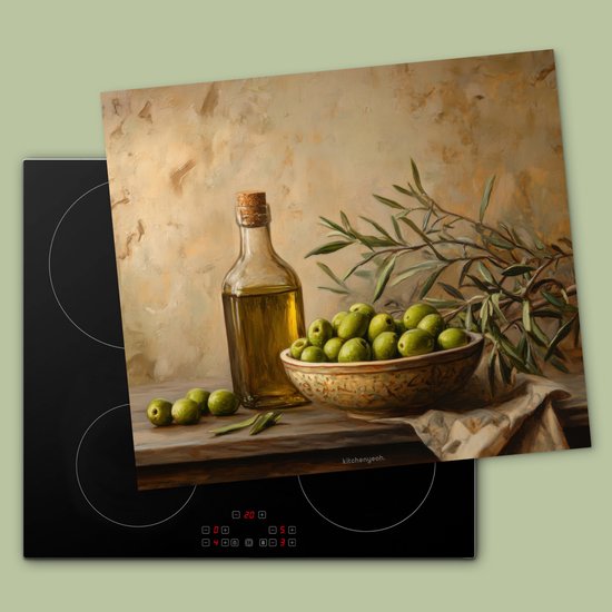 Planche à découper avec nature morte d'olives vertes, bouteille d'huile d'olive et branches d'olivier sur une plaque de cuisson à induction.