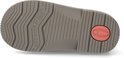 Onderkant van een bruine suède laars met "extreme Flex" grip en een roze detail op de hak.