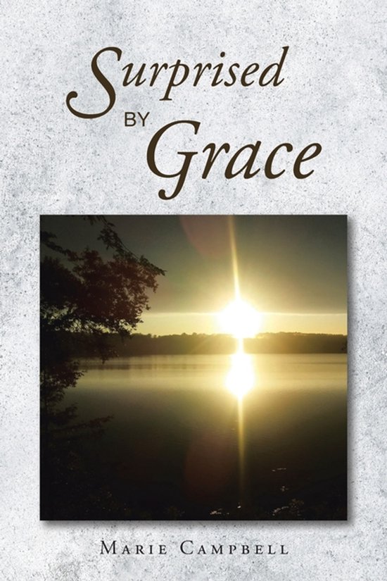 Boek 'Surprised By Grace' van Marie Campbell, met op de voorkant een zonsopgang boven een mistig meer.