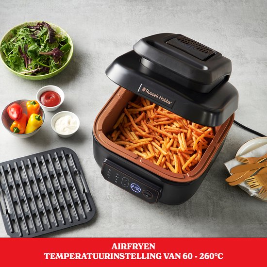 Zwarte Russell Hobbs airfryer met veel frietjes, naast een salade. Tekst: Airfryer temperatuurinstelling van 60-260°C.