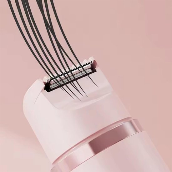 Roze scheerkop van een ladyshave met zwarte haren die erin worden getrokken.