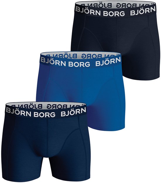 Drie Björn Borg boxershorts in het donkerblauw, blauw en navy, met witte logo-elastiekband.