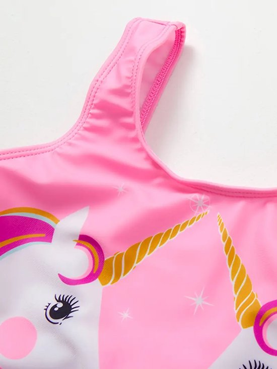 Roze badpak met print van twee eenhoornhoorns en glitters. De schouderbandjes zijn roze.