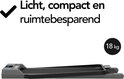Grijze loopband, opgevouwen en plat, met het gewicht van 18 kg vermeld.