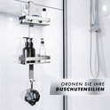 Zilverkleurige douche organizer met 2 mandjes, met dispensers en een washandje eraan.