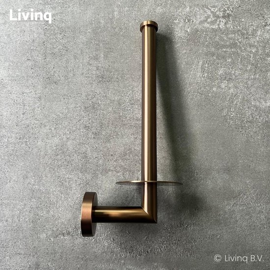 Bronzen reserverolhouder met L-vormige arm, gemonteerd op een grijze muur.