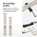 Twee zilverkleurige metalen bandjes en een tool om de maat aan te passen.