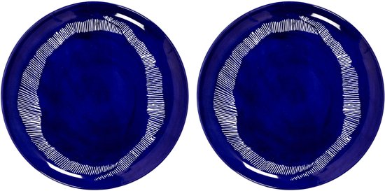 Deux bols ronds bleu foncé avec motif rayé blanc en cercle.