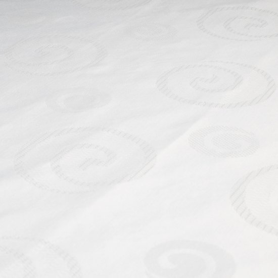 Textuur van de witte Puck boxmatras met ingeweven cirkels.