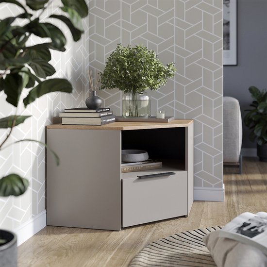 Grijze VICCO Wido kast in de hoek van een woonkamer, met houtlook blad, open vak en lade.