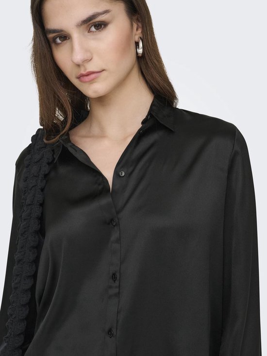 Close-up van zwarte satijnen blouse met knoopjes.