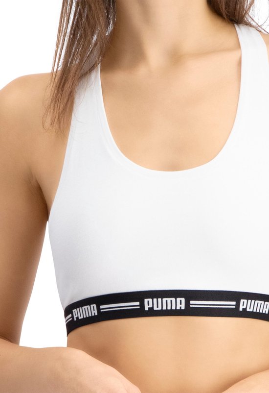 Wit Puma sportbh topje met zwarte band met Puma logo.