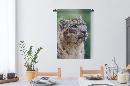 Wandkleed Sneeuwluipaard - Sneeuwluipaard die omhoog kijkt Wandkleed katoen 60x90 cm - Wandtapijt met foto