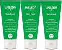 Drie WELEDA Skin Food tubes naast elkaar. Groene tubes met witte dop. "Voedende alles-in-één crème voor gezicht en lichaam. Droge en ruwe huid."