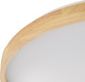 Close-up van de houten rand van een ronde plafondlamp.