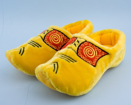 Gele pluche klompsloffen met geborduurde rode en oranje versieringen en zwarte lijnen.