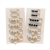 Sets gouden veiligheidsspelden met witte en zwarte imitatieparels, met en zonder strass.