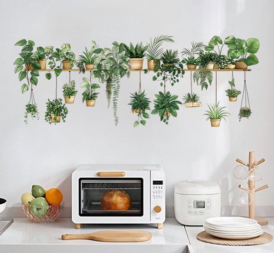 Autocollant avec plantes en pots dorés sur une étagère murale, au-dessus d'une cuisine blanche.