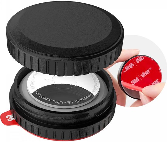 Étui de protection noir pour AirTag, ouvert avec un AirTag blanc visible et un ruban adhésif 3M VHB rond.