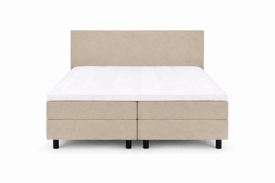 Beige boxspringbed met hoofdbord, twee aparte matrassen en topper, van voren gezien.