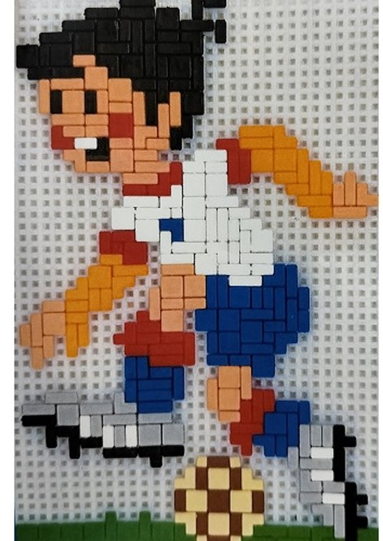 Pixelkunst mozaïek van een lachende jongen in een rood, wit en blauw voetbaltenue dat de bal trapt. Met oranje mouwen en groene grasdetails.