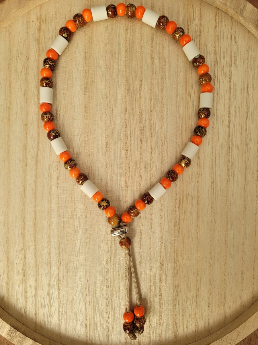 Anti Vlooienband / Tekenband EM-X Kralen 25-30cm ORANJE/BRUIN (GEEN RECHT OP RETOUR)