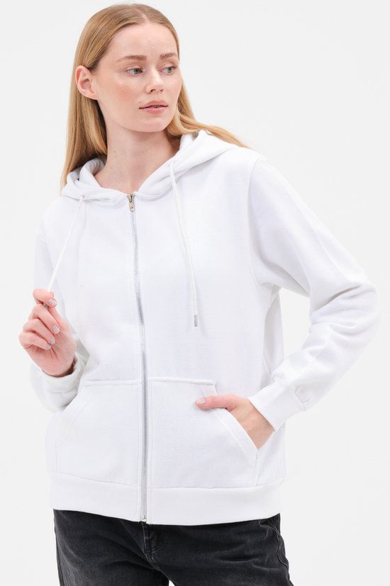 Model met witte capuchontrui met rits, steekt hand in zak.