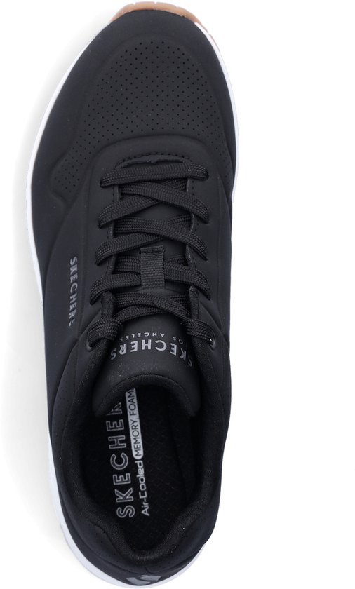 Bovenkant van een zwarte Skechers sneaker met veters en tekst.