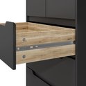 Gros plan de l'intérieur en bois d'un tiroir ouvert d'une commode noire.