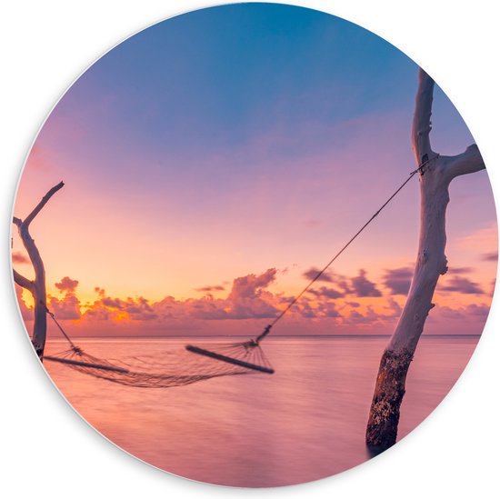 PVC Schuimplaat Muurcirkel - Hangmat tussen Kale Takken in de Zee tijdens Zonsondergang - 60x60 cm Foto op Muurcirkel (met ophangsysteem)