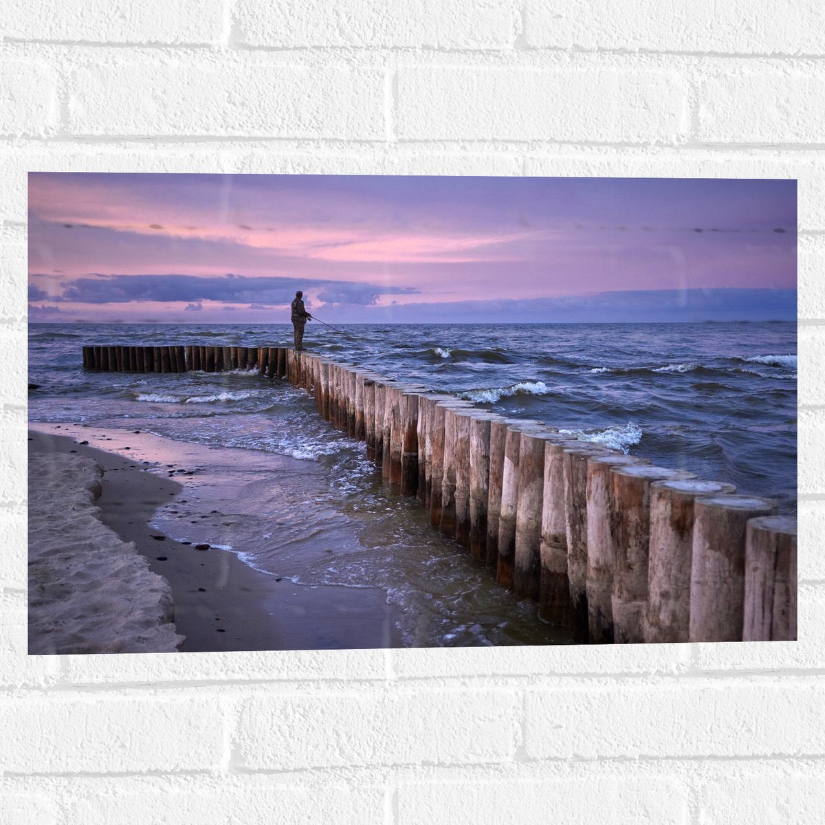 Muursticker - Man op Palen in de Wilde Zee tijdens het Vissen - 60x40 cm Foto op Muurstick