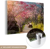 MuchoWow® Glasschilderij 120x80 cm - Schilderij acrylglas - De roze sakura bladeren in de boom langs de weg - Foto op glas - Schilderijen