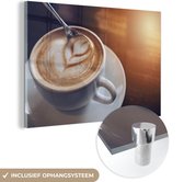 MuchoWow® Glasschilderij 30x20 cm - Schilderij acrylglas - Een lepel roert door de schuimlaag van een bakje koffie - Foto op glas - Schilderijen
