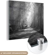MuchoWow® Glasschilderij 90x90 cm - Schilderij acrylglas - Hert op de weg in het bos - zwart wit - Foto op glas - Schilderijen